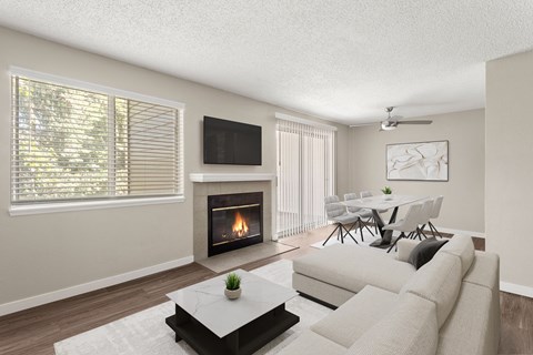 a living room with a couch and a table and a fireplace